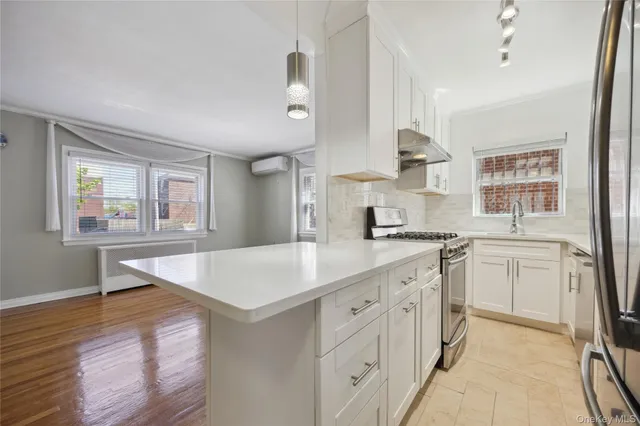 a kitchen with a sink stove and cabinets