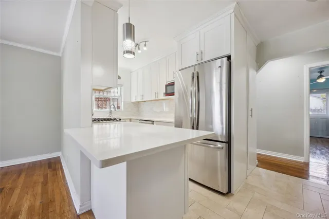 a kitchen with stainless steel appliances a refrigerator and a stove