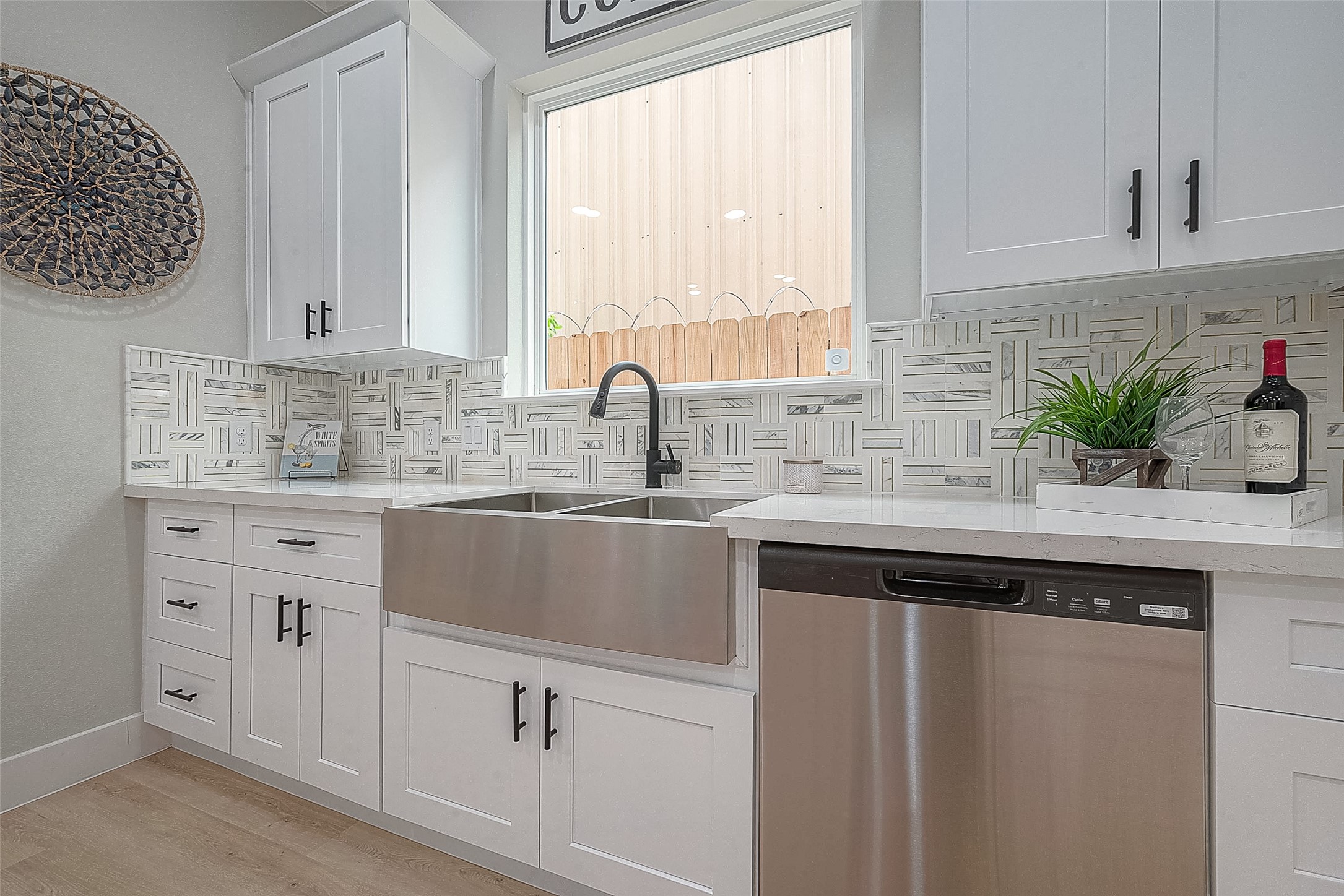 3837 Mainer Street Houston, TX 77021 - Photo 11 of 19 a kitchen with white cabinets and a window