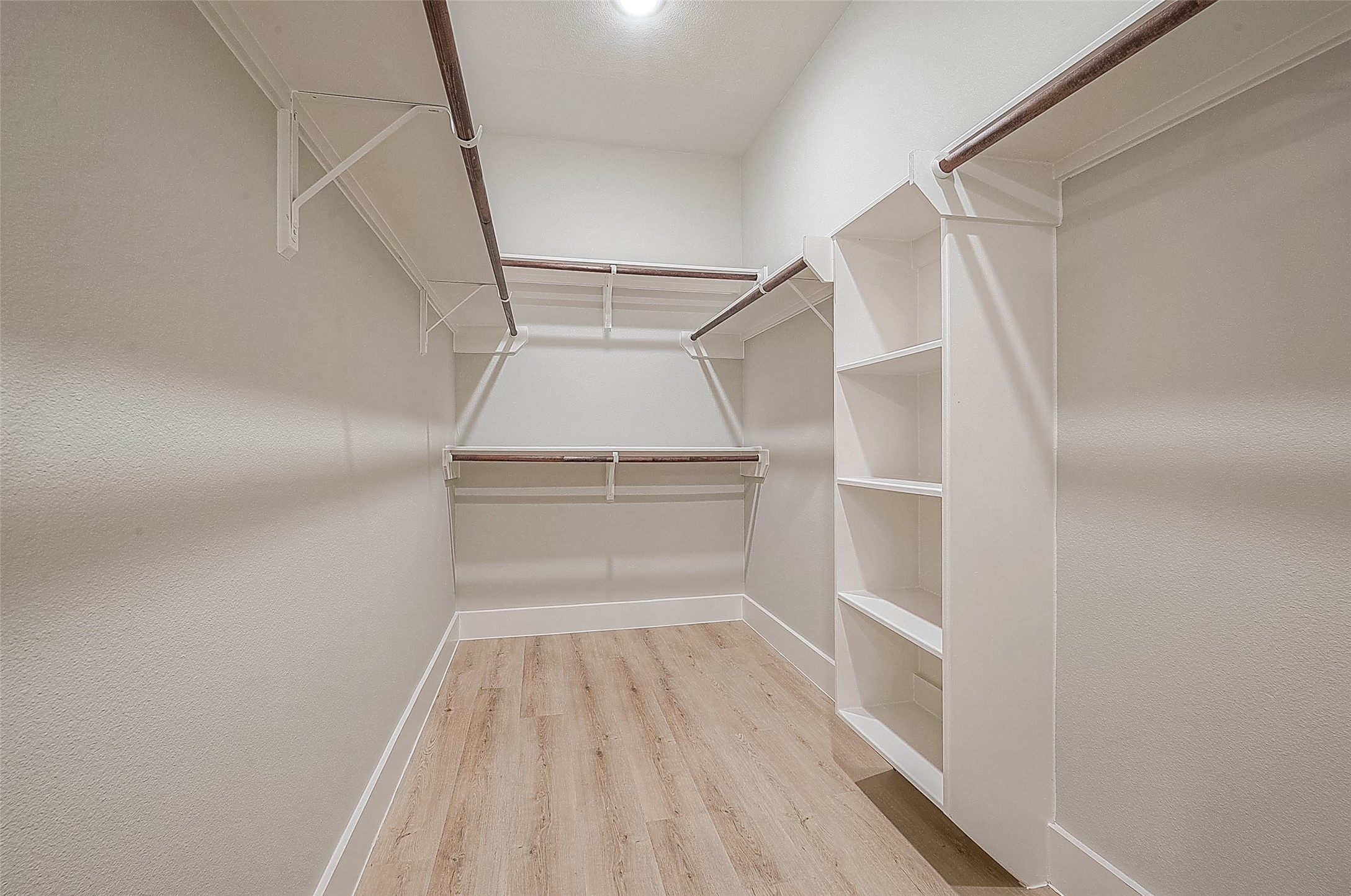 3837 Mainer Street Houston, TX 77021 - Photo 15 of 19 a view of walk in closet with empty racks