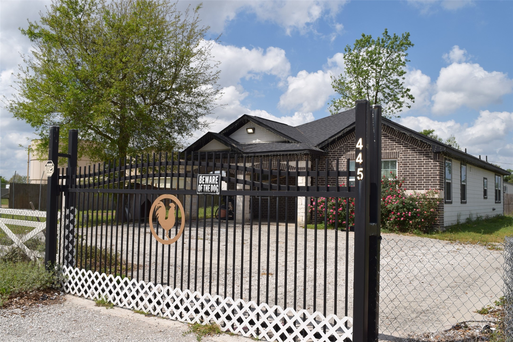 445 Road 5102 Cleveland, TX 77327 - Photo 2 of 36 a view of a brick house with a wooden fence