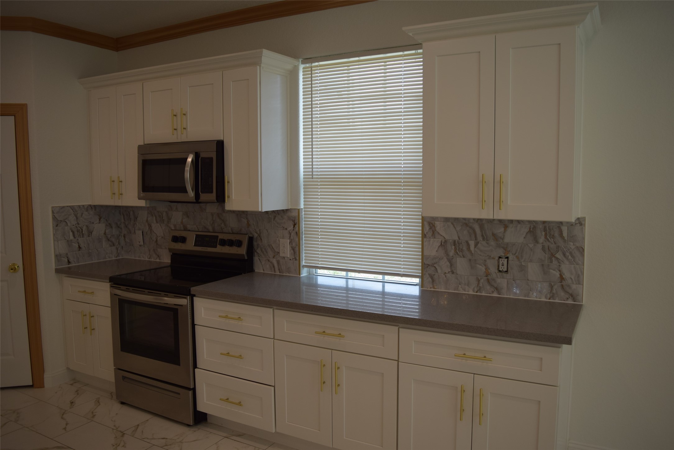 445 Road 5102 Cleveland, TX 77327 - Photo 5 of 36 a kitchen with white cabinets and black appliances