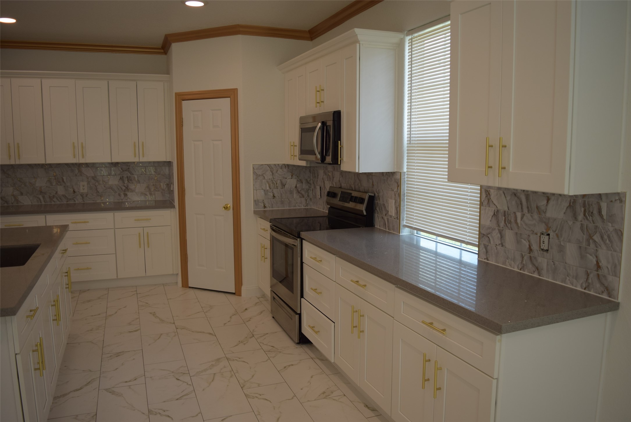 445 Road 5102 Cleveland, TX 77327 - Photo 8 of 36 a kitchen with granite countertop a sink and a stove top oven