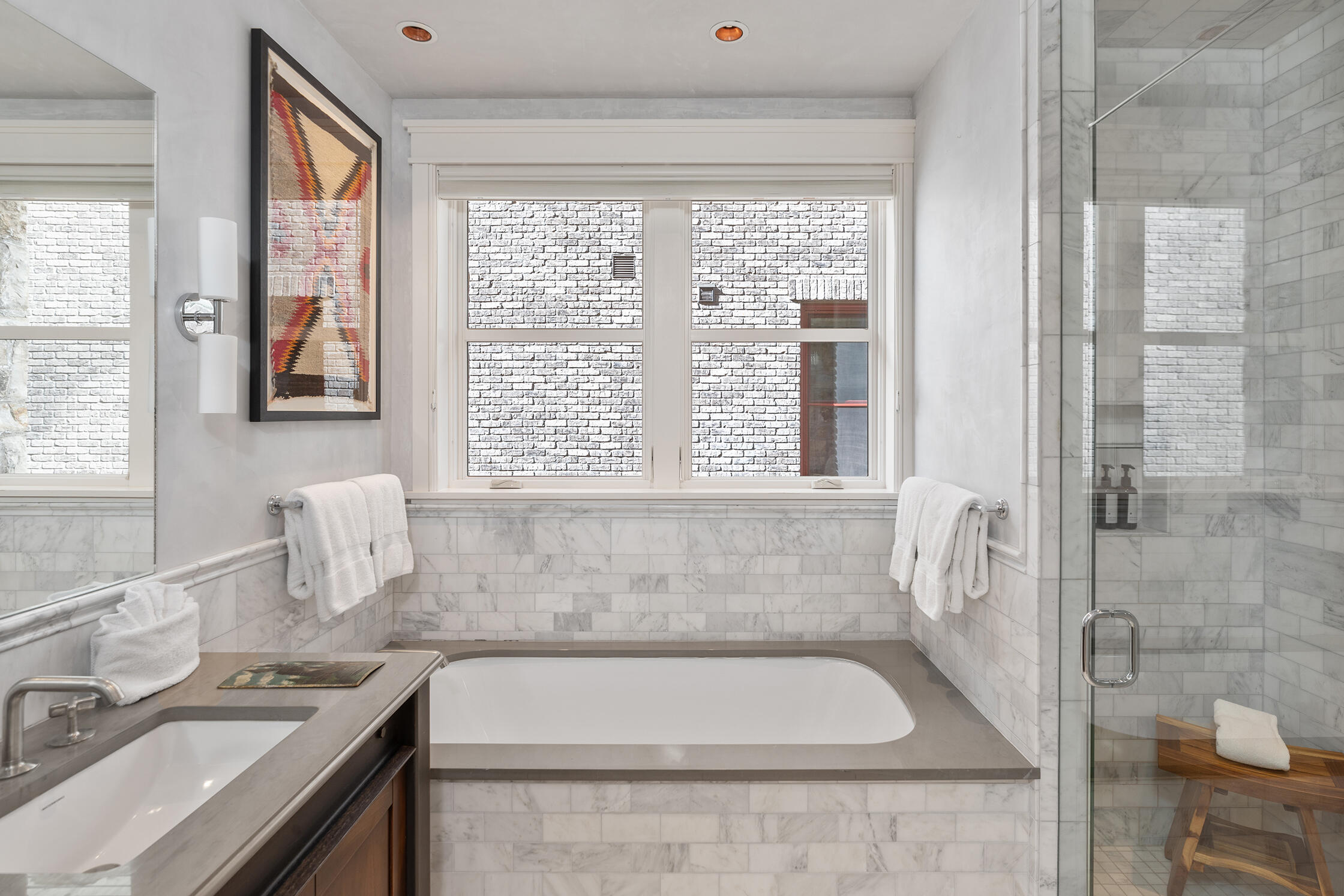 398 South Davis Street, Unit SW 201 Telluride, CO 81435 - Photo 19 of 23 a bathroom with a granite countertop tub a sink and a window