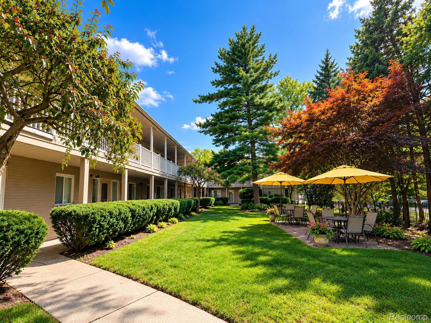475 South Adams Road, Unit 8 Birmingham, MI 48009 - Photo 1 of 15 Expansive green lawn with mature trees and a paved walkway