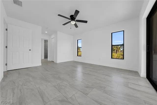 a bathroom with a granite countertop sink a toilet a mirror and shower