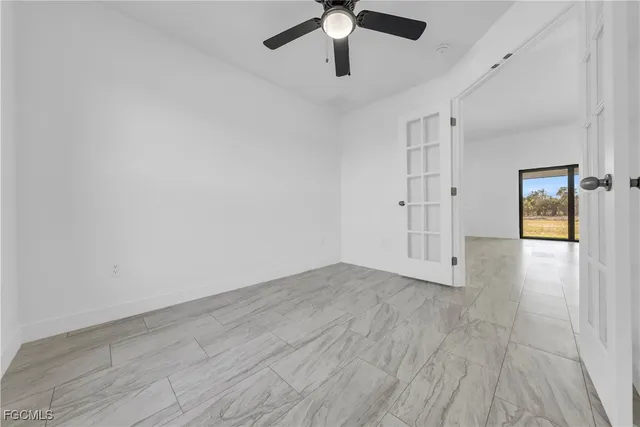 a very nice looking room with a large window and chandelier