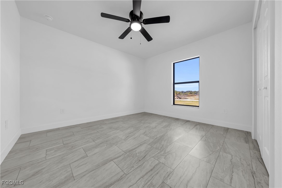 7979 16th Place LaBelle, FL 33935 - Photo 16 of 36 an empty room with wooden floor ceiling fan and window