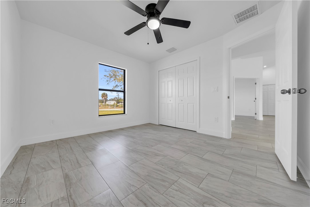 7979 16th Place LaBelle, FL 33935 - Photo 17 of 36 wooden floor in an empty room with a window