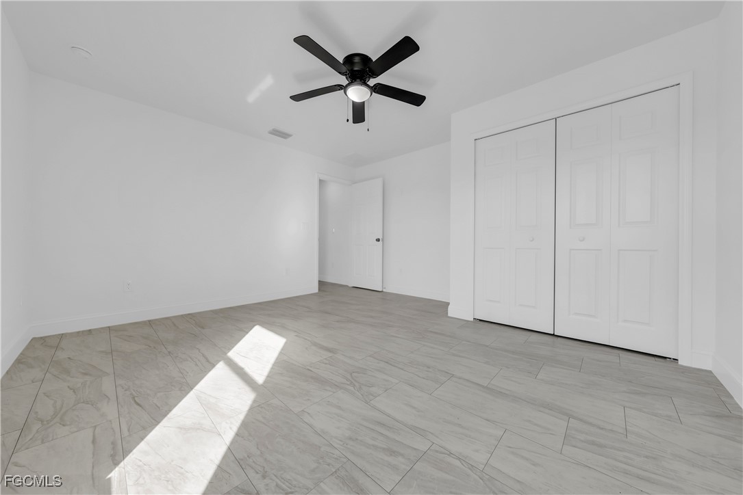 7979 16th Place LaBelle, FL 33935 - Photo 20 of 36 an empty room with closet and ceiling fan