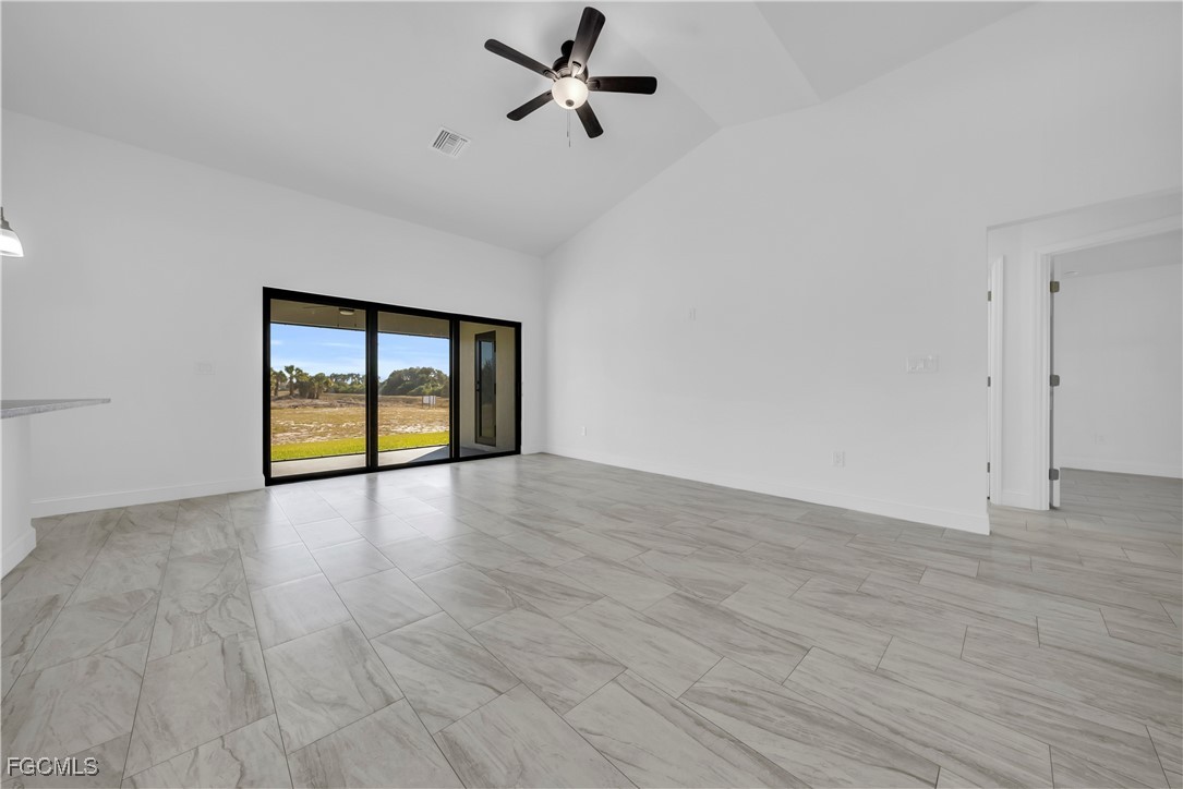 7979 16th Place LaBelle, FL 33935 - Photo 5 of 36 a view of an empty room with a window and wooden floor