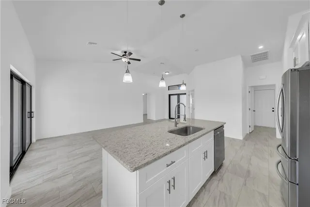 a bathroom with a granite countertop sink a toilet and bathtub