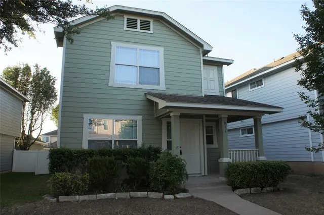 a front view of a house with plants