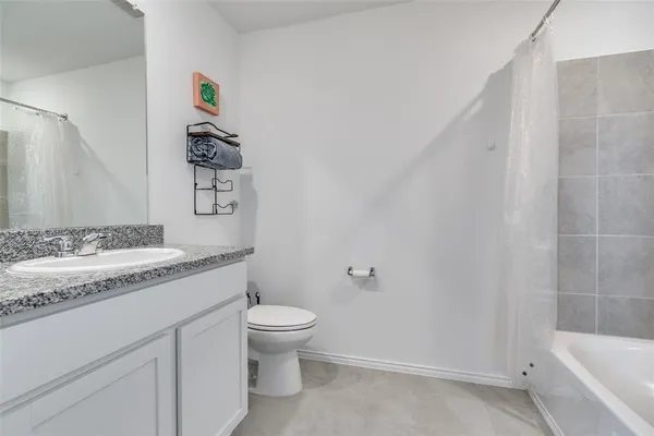 a bathroom with a granite countertop sink toilet and vanity