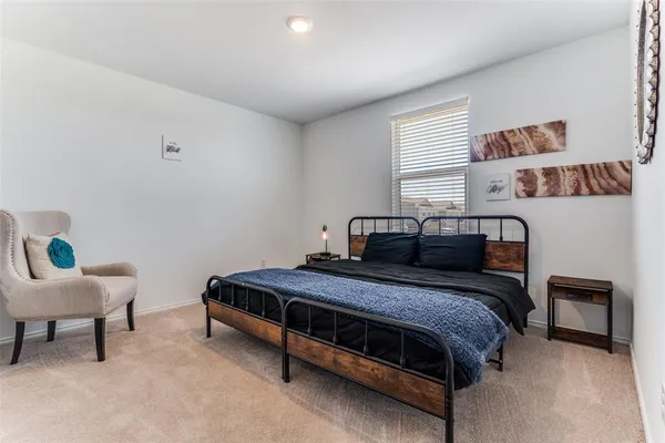 a bedroom with a bed and a lounge chair