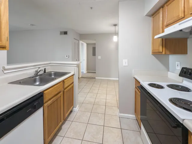 a kitchen with a sink stove and cabinets