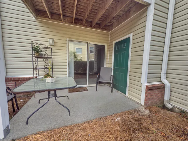 a balcony with table and chairs