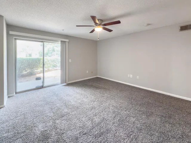 a view of a livingroom with a ceiling fan and window