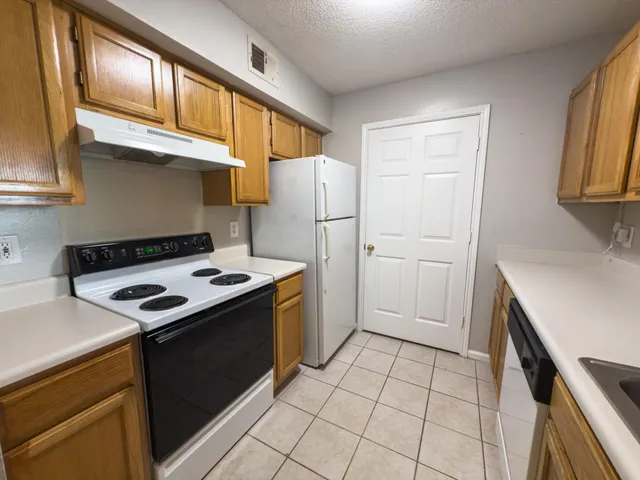 a kitchen with a stove and a refrigerator