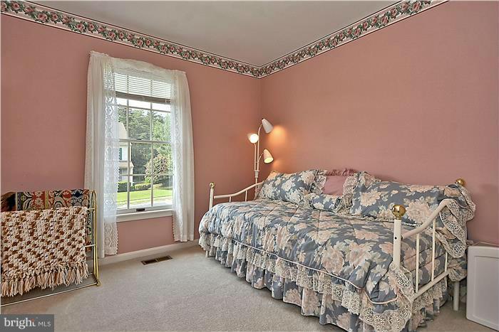 4232 Devonwood Way Woodbridge, VA 22192 - Photo 16 of 30 a bed sitting in a bedroom next to a window