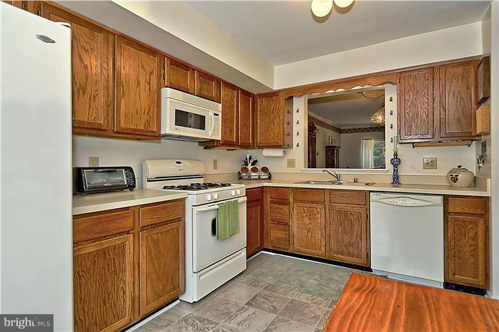 4232 Devonwood Way Woodbridge, VA 22192 - Photo 3 of 30 a kitchen with stainless steel appliances granite countertop a sink and cabinets