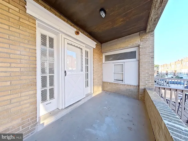 a view of a porch with wooden floor and fence