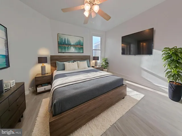 a bedroom with a bed and a flat screen tv