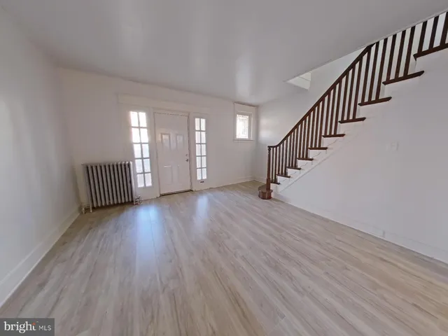 a view of an entryway with wooden floor