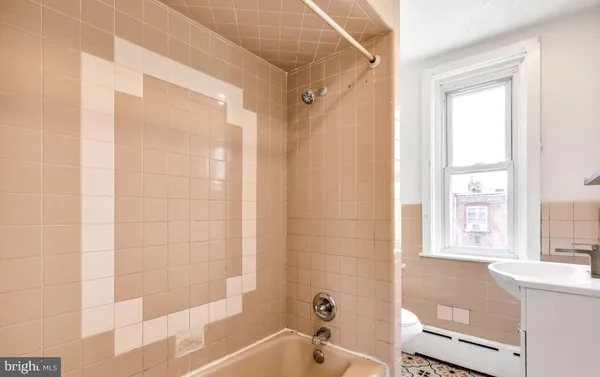 a bathroom with a bathtub and shower