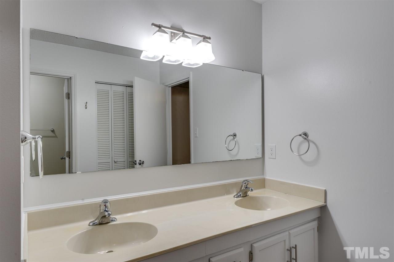 5757 3 Oaks Drive Raleigh, NC 27612 - Photo 14 of 20 a bathroom with a sink and a mirror