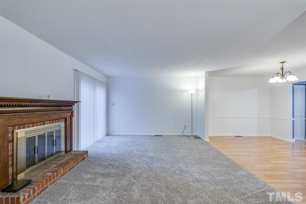 5757 3 Oaks Drive Raleigh, NC 27612 - Photo 9 of 20 a view of an empty room with a fireplace