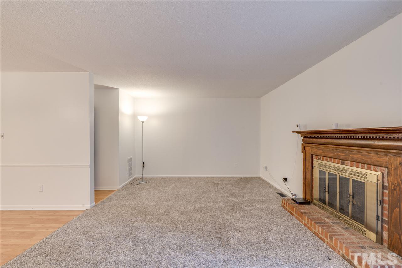5757 3 Oaks Drive Raleigh, NC 27612 - Photo 10 of 20 a view of an empty room and a fireplace