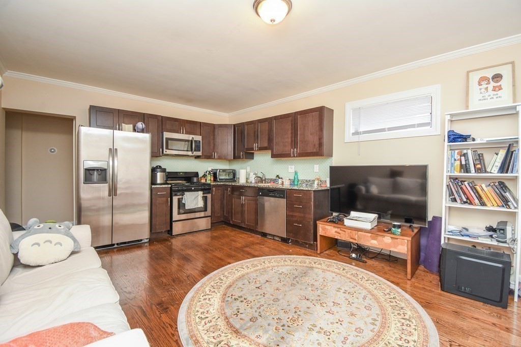 75 Elm Street Watertown, MA 02472 - Photo 4 of 12 a kitchen with stainless steel appliances granite countertop a refrigerator sink and stove