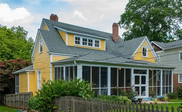 a view of a hallway with wooden floor and stairs