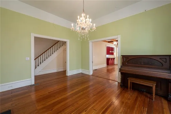 a kitchen with stainless steel appliances granite countertop a sink a stove and a wooden cabinets