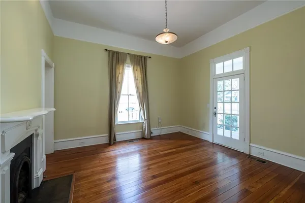 a living room with hardwood floor and a fireplace