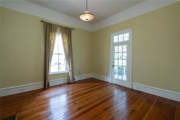 a kitchen with stainless steel appliances granite countertop a stove cabinets and wooden floor