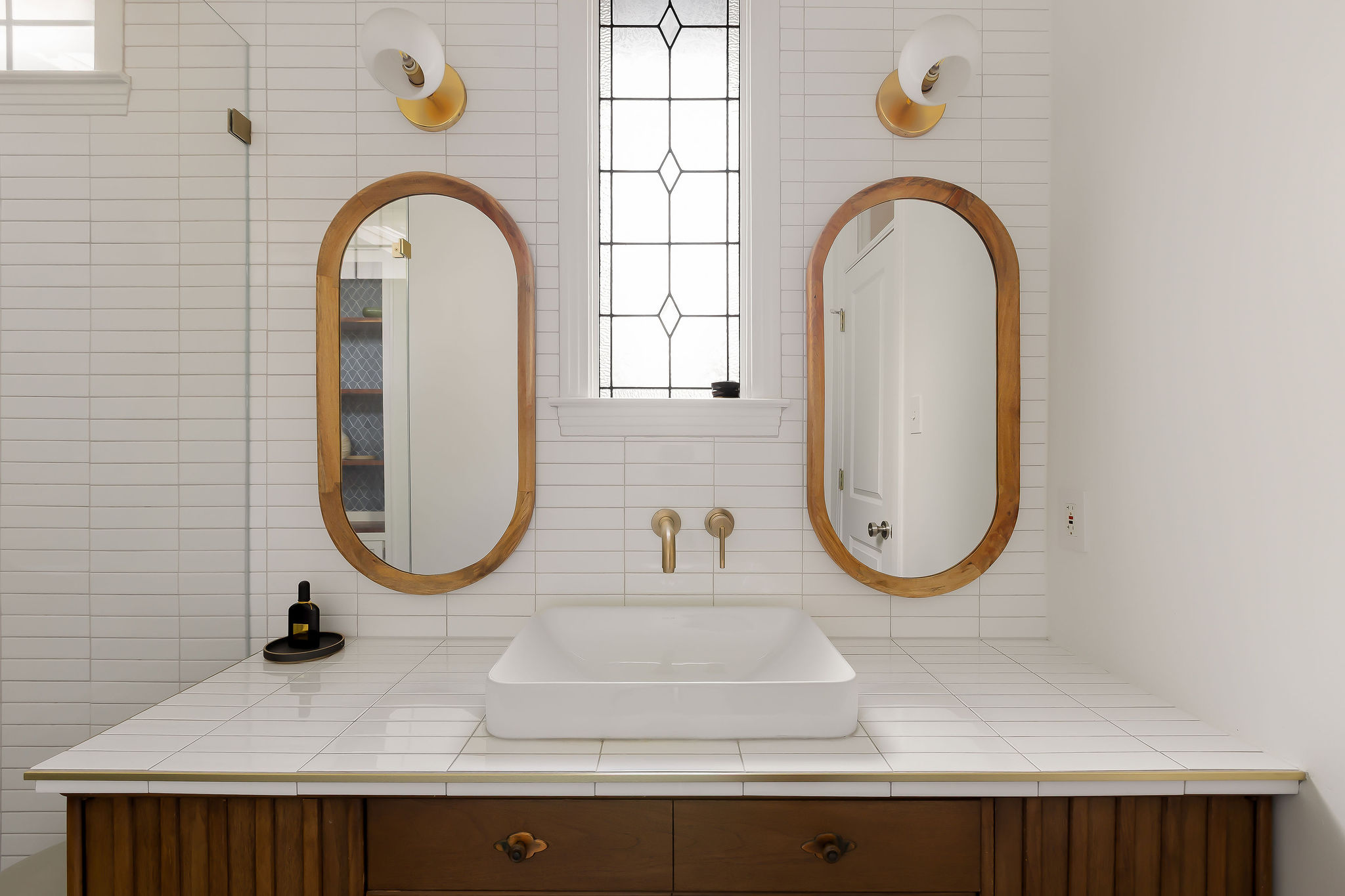 5108 Eilers Avenue Austin, TX 78751 - Photo 13 of 39 Beautifully updated primary bathroom with a walk-in shower. Vintage repurposed vanity