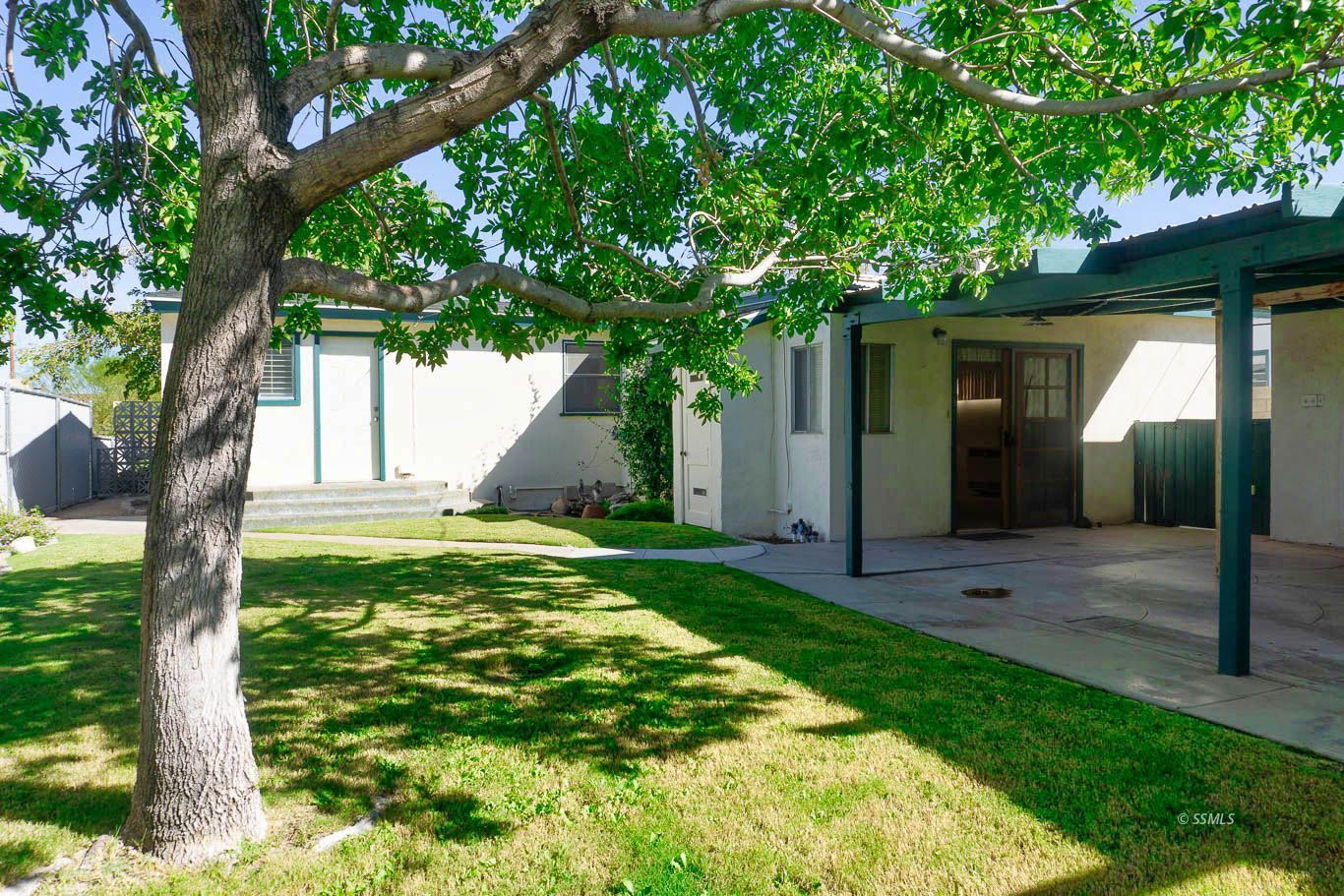 425 North Alvord Street Ridgecrest, CA 93555 - Photo 37 of 43 a view of a house with a tree in a yard
