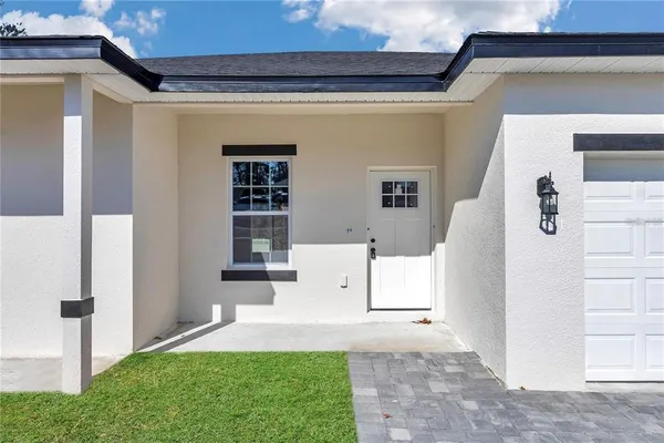 a view of a house with a yard and garage