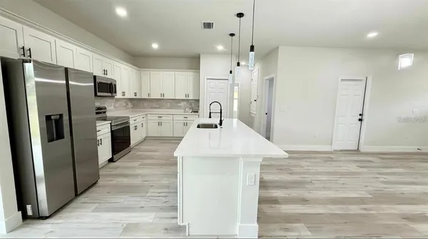 a view of kitchen with wooden floor