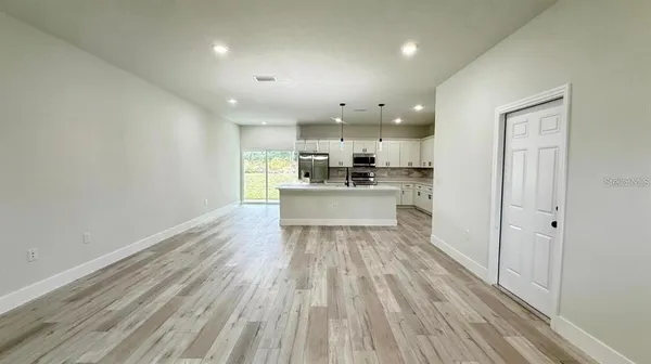 a view of a kitchen with a stove cabinets and wooden floor