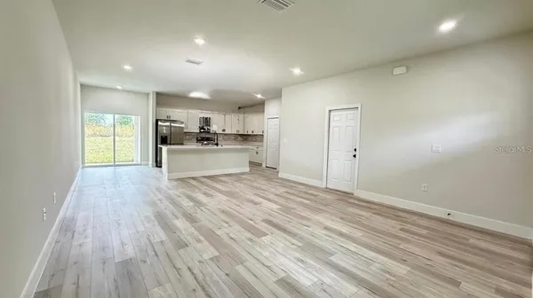 a kitchen with a sink window and cabinets
