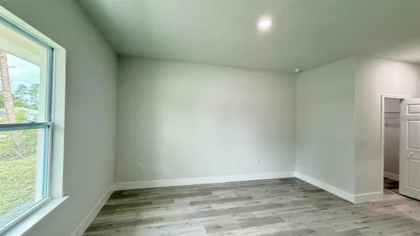 a view of a room with wooden floor