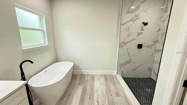a bath tub sitting next to a white sink