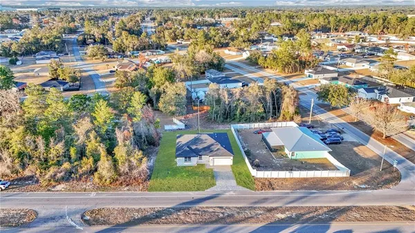 an aerial view of a house with a yard and a fountain