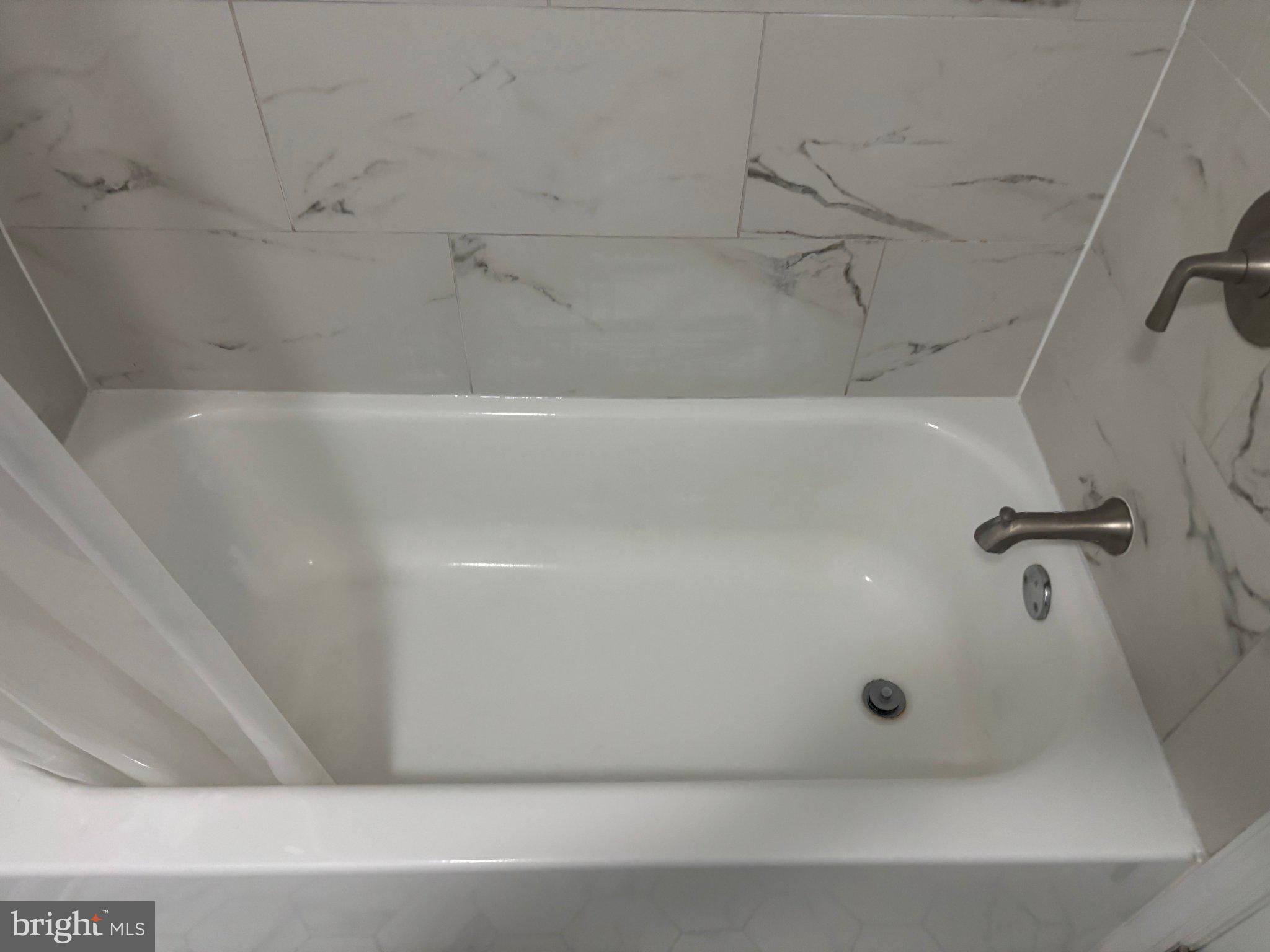 14800 Rydell Road, Unit 201 Centreville, VA 20121 - Photo 21 of 28 Sleek tub in a modern bathroom.