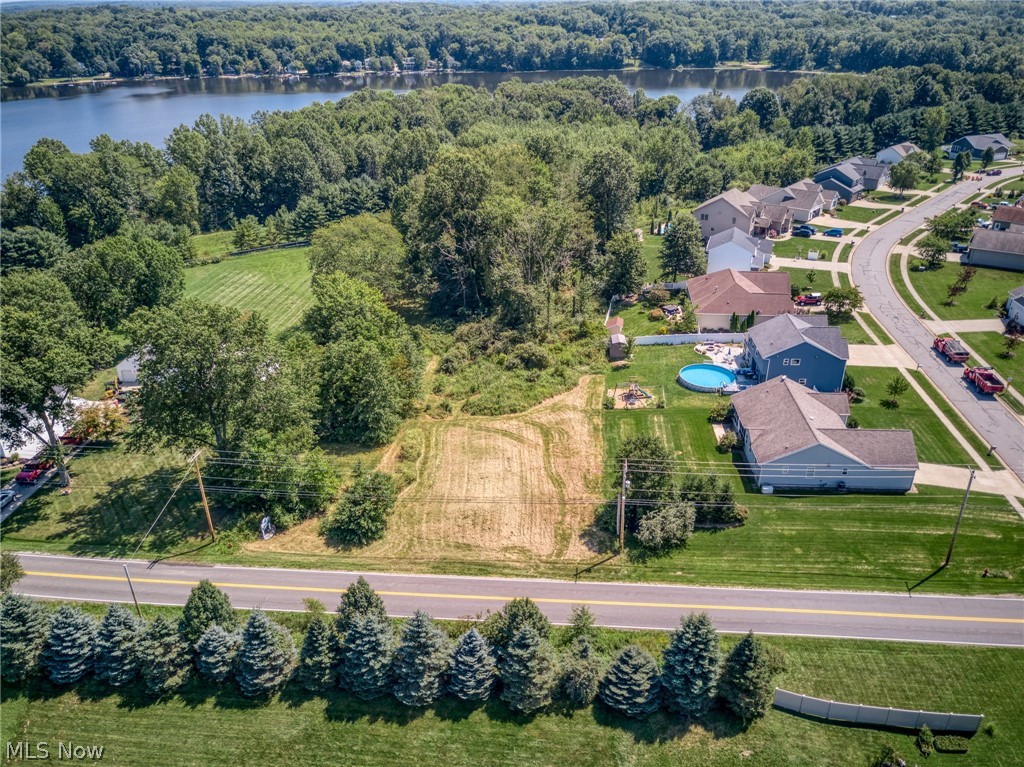 1808 Sandy Lake Road Ravenna, OH 44266 - Photo 3 of 30 Expansive land parcel with direct road frontage, surrounded by mature trees, and a distant body of water