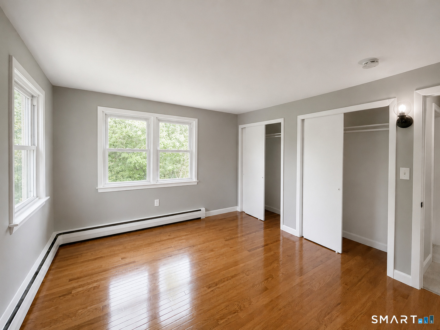 341 Harland Road Norwich, CT 06360 - Photo 11 of 29 an empty room with wooden floor and windows