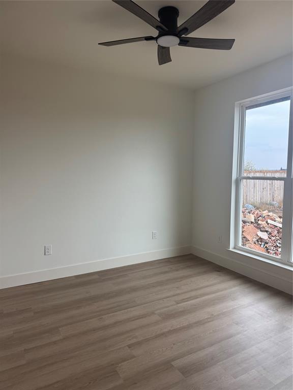 150 Ridge Road Tuscola, TX 79562 - Photo 11 of 12 an empty room with wooden floor and windows